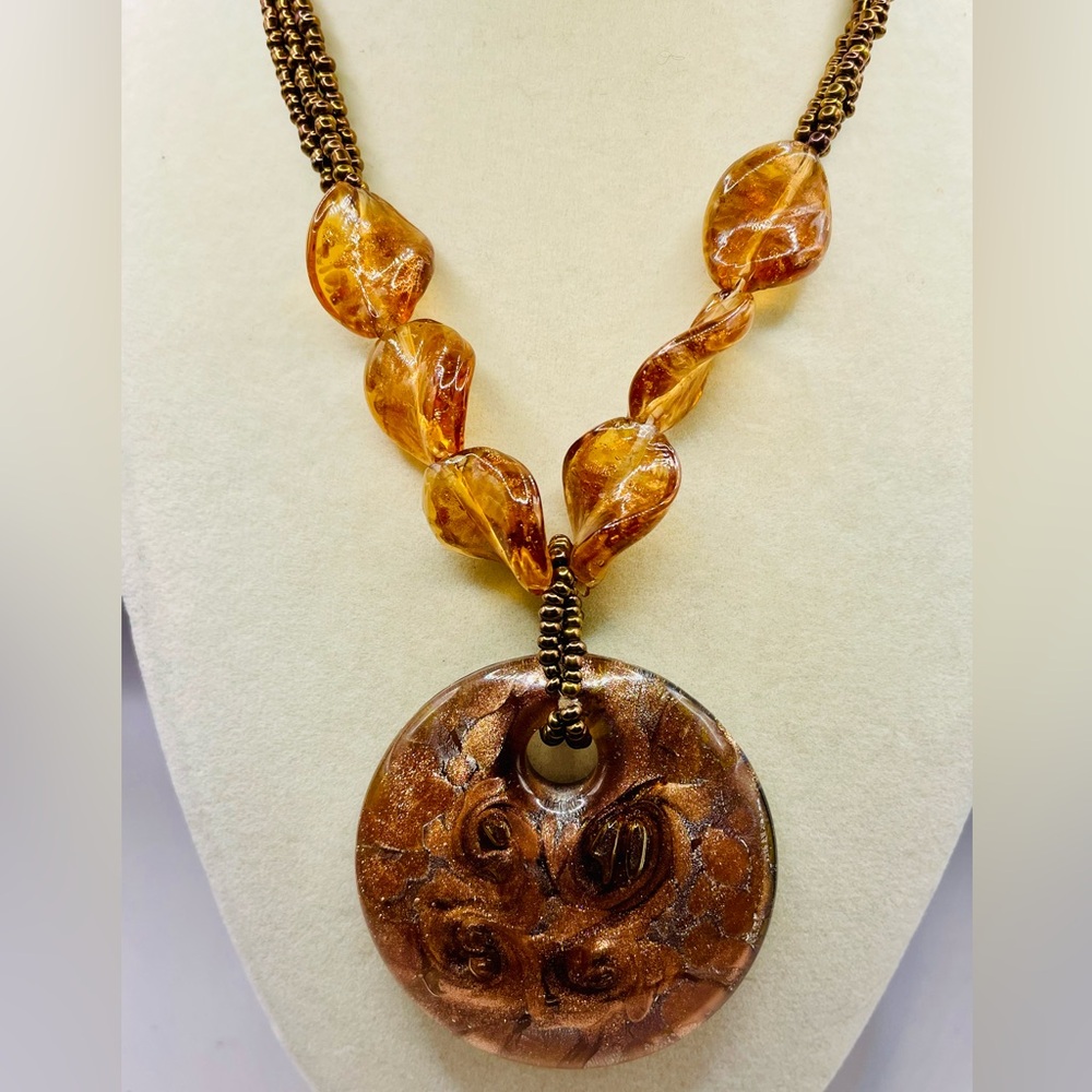Circle brown fire blown art glass pendant on a beaded necklace from the Artesian
